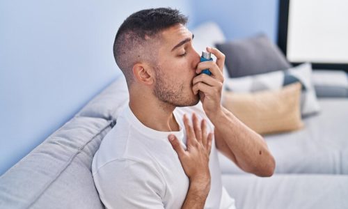 young-hispanic-man-using-inhaler-sitting-sofa-home_839833-7372